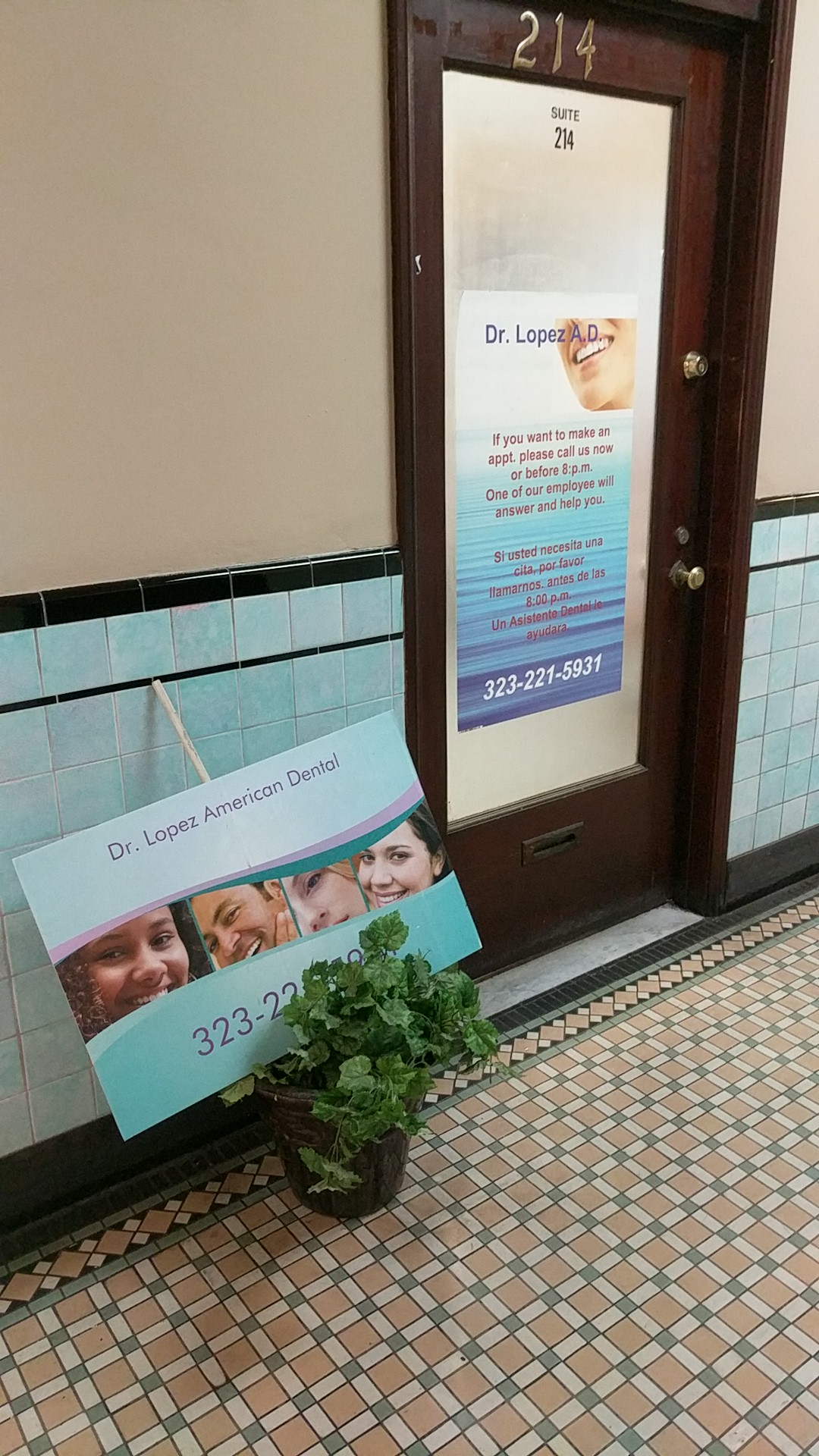 Entrance door with office sign and plant