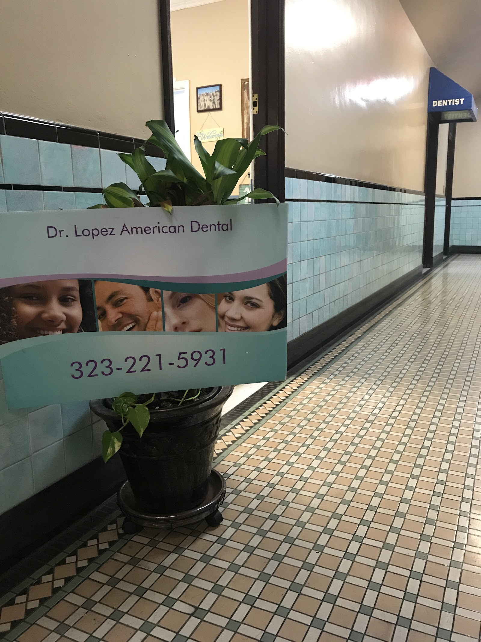 Dr. Lopez American Dental sign in the tiled hallway outside the suite