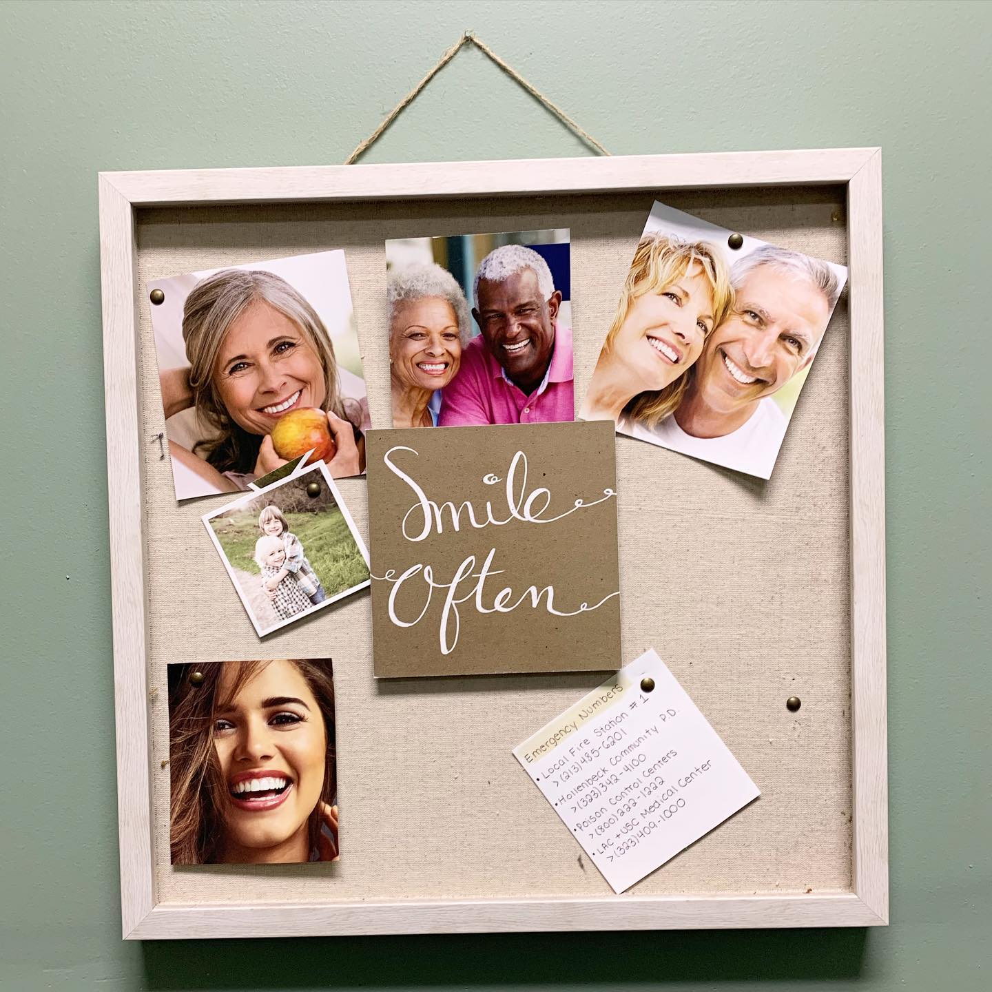 A framed board in the office that reads Smile Often